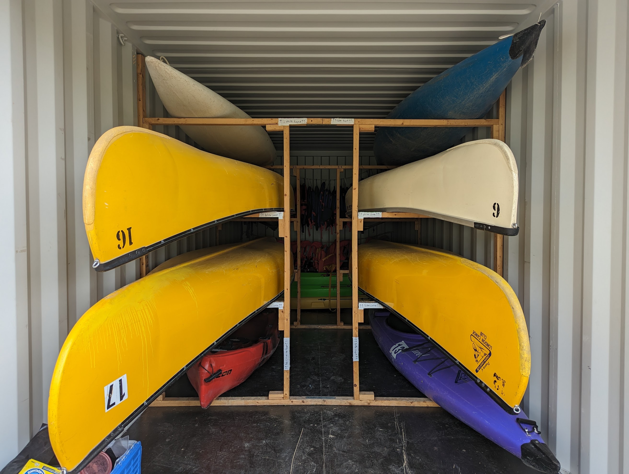 A variety of canoes and kayaks on racks
