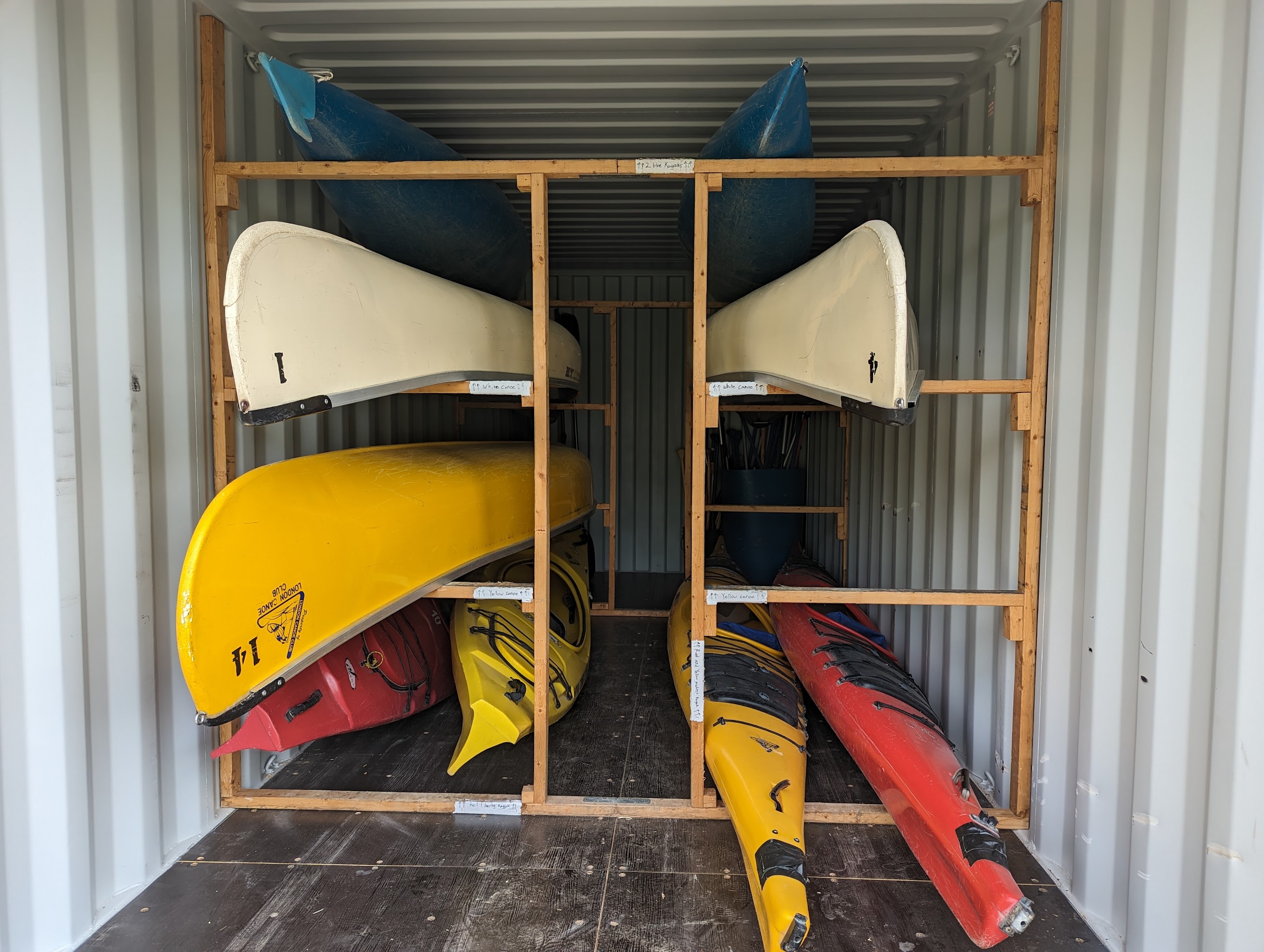A variety of canoes and kayaks on racks